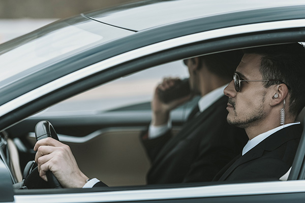 Security professional driving a car