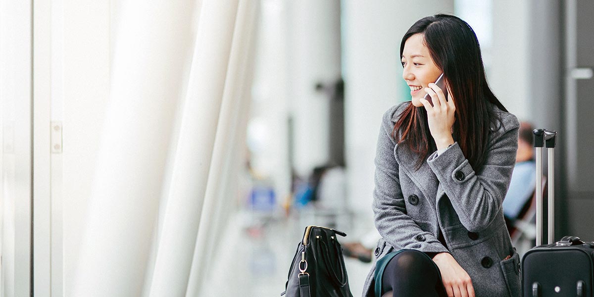 Asian woman in airport on the phone